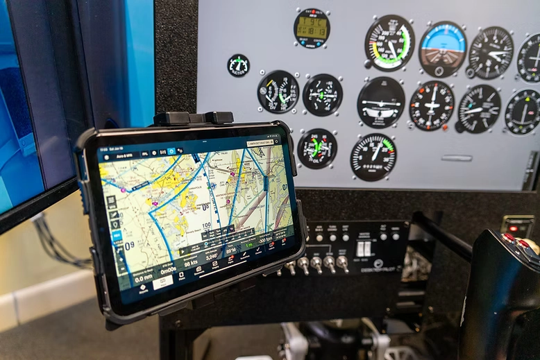 Pilot using a simulator and tablet at Solid Ground Aviation